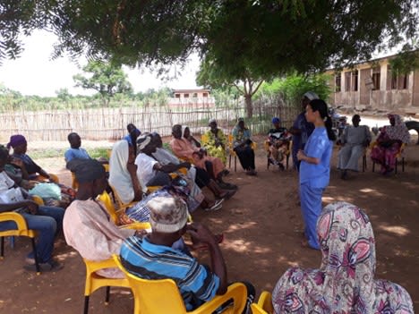 Dian and volunteers give an educational presentation.