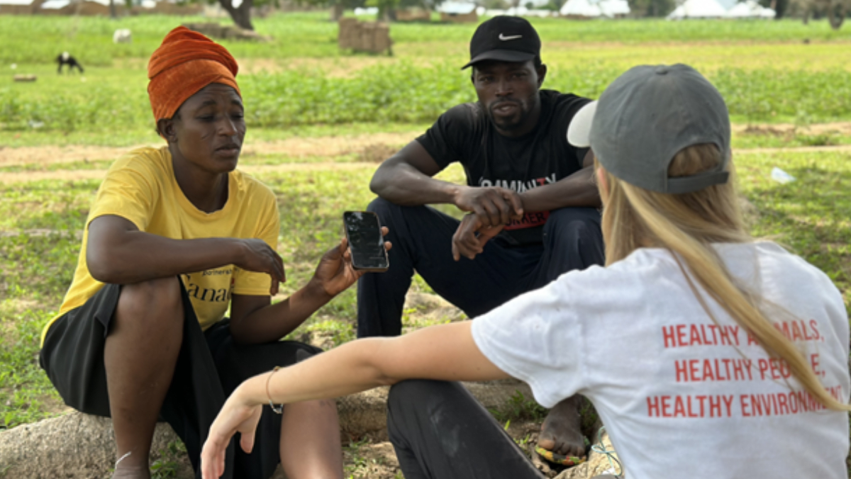 A VETS volunteer chatting with community animal health workers in Ghana